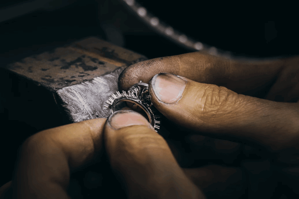 image Close-up of artisan hands crafting a detailed silver ring, showcasing fine jewelry making with intricate design elements. | Sky Rye Design Close-up of artisan hands crafting a detailed silver ring, showcasing fine jewelry making with intricate design elements.