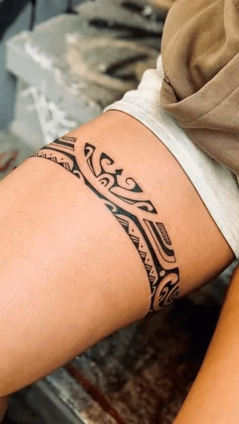 image Intricate tribal tattoo design encircles a person's thigh, showcasing bold black ink patterns and detailed craftsmanship. | Sky Rye Design Intricate tribal tattoo design encircles a person's thigh, showcasing bold black ink patterns and detailed craftsmanship.