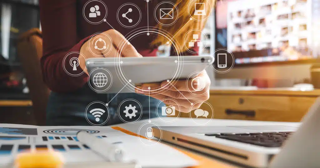 link-building-strategy-61f2761994bcd-sej Person using a tablet with network icons floating, illustrating digital communication and technology in a modern office setting. | Sky Rye Design Person using a tablet with network icons floating, illustrating digital communication and technology in a modern office setting.