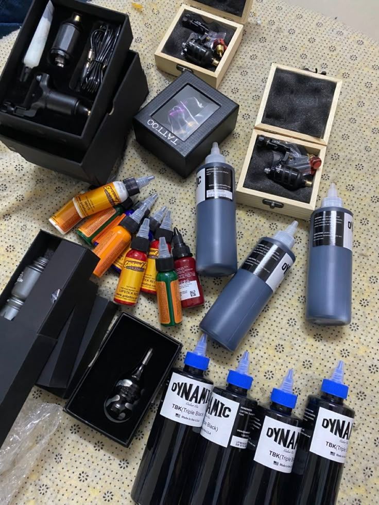 new job Tattoo supplies including inks, tattoo machines, and accessories in various boxes on a beige surface. Ideal for professional tattoo artists. | Sky Rye Design Tattoo supplies including inks, tattoo machines, and accessories in various boxes on a beige surface. Ideal for professional tattoo artists.