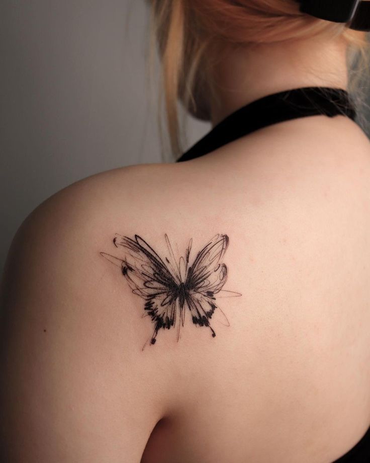 tattoideas Delicate butterfly tattoo on a shoulder, featuring intricate black ink design with sketchy outlines. | Sky Rye Design Delicate butterfly tattoo on a shoulder, featuring intricate black ink design with sketchy outlines.