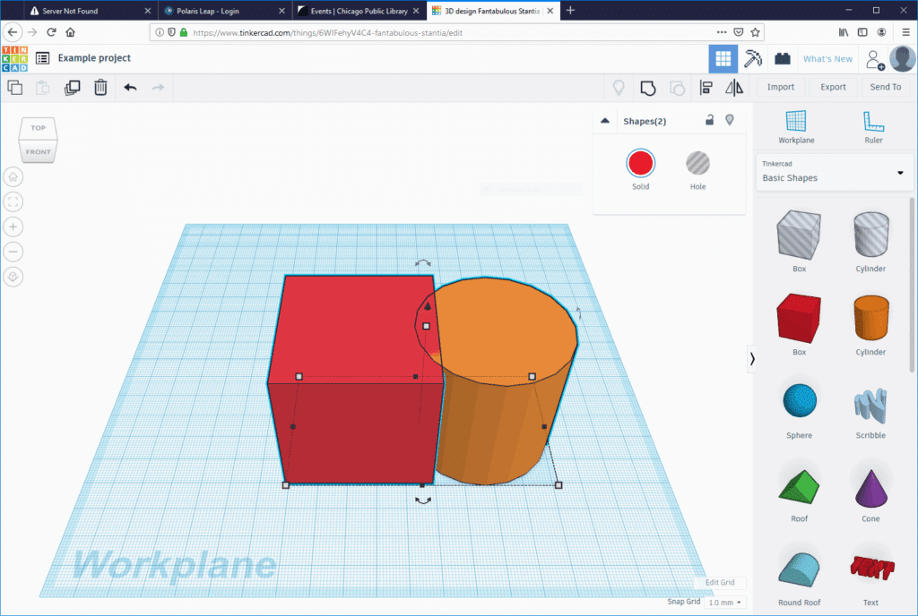 3D design software interface showing a red cube and orange cylinder on a grid workplane, basic shape tools visible.