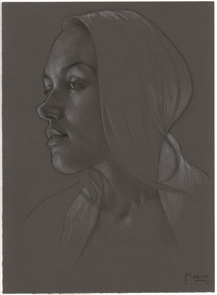 Pencil sketch of a woman's side profile on dark paper, highlighting delicate features and a serene expression.