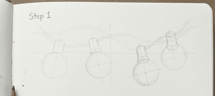 tutorial-step-1 4 Sketch of string lights, with bulbs and wires. Step 1 of a drawing guide in a notebook with a pencil in the bottom left corner. | Sky Rye Design Sketch of string lights, with bulbs and wires. Step 1 of a drawing guide in a notebook with a pencil in the bottom left corner.