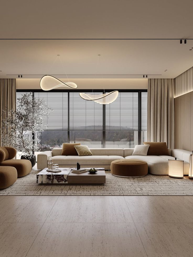 Modern living room with neutral tones, featuring a large sofa, stylish lighting, and floor-to-ceiling windows with blinds for natural light.
