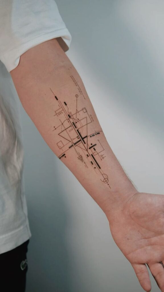 Abstract geometric tattoo on forearm with intricate lines and shapes, showcasing a minimalist black ink design.