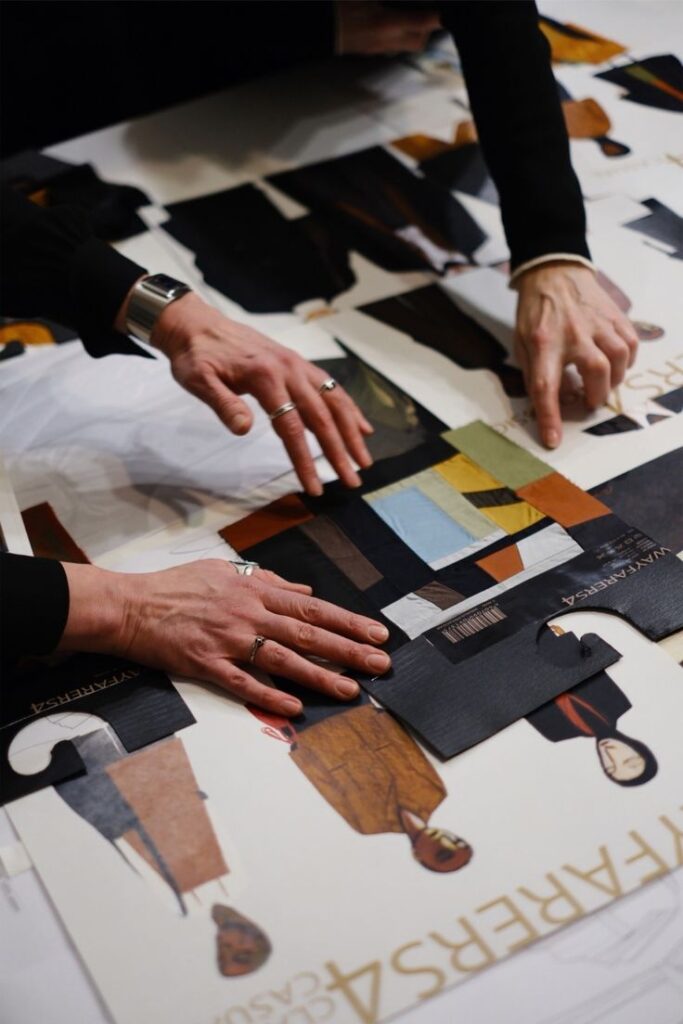 Fashion designers arranging colorful fabric swatches and sketches on a table, showcasing collaborative creative process in fashion design.