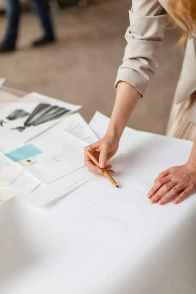 Швейный блог 1 Designer sketching fashion drawings on white paper with pencils and templates on a table. Creative workspace atmosphere. | Sky Rye Design Designer sketching fashion drawings on white paper with pencils and templates on a table. Creative workspace atmosphere.