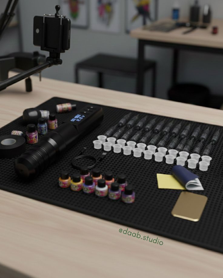 ✨ Tattoo equipment organized on a table with ink bottles, needles, and tools, ready for use in a professional studio setting. | Sky Rye Design Tattoo equipment organized on a table with ink bottles, needles, and tools, ready for use in a professional studio setting.