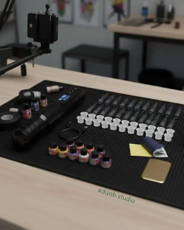 Tattoo equipment organized on a table with ink bottles, needles, and tools, ready for use in a professional studio setting.