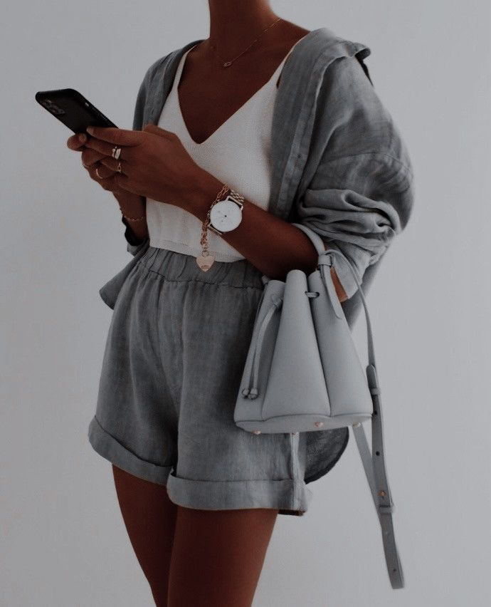 ❥ babestx Stylish woman in gray outfit holding smartphone and gray handbag, wearing watch and jewelry, showcasing modern fashion and accessories. | Sky Rye Design Stylish woman in gray outfit holding smartphone and gray handbag, wearing watch and jewelry, showcasing modern fashion and accessories.