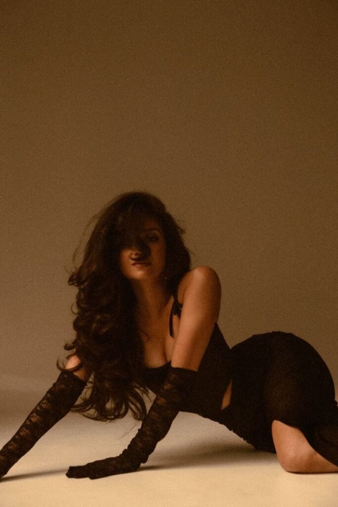 Женский фотограф Москва Кашпирова Карина_ Женственная фотосессия в студии Model in elegant black dress and long gloves poses dramatically on the floor, highlighting chic style and sophisticated fashion. | Sky Rye Design Model in elegant black dress and long gloves poses dramatically on the floor, highlighting chic style and sophisticated fashion.