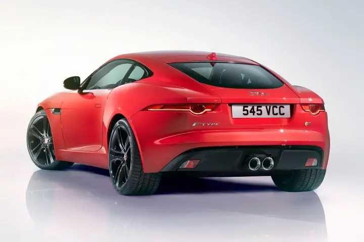 Sleek red sports car with black rims, rear view highlighting aerodynamic design and dual exhaust, set against a gradient background.