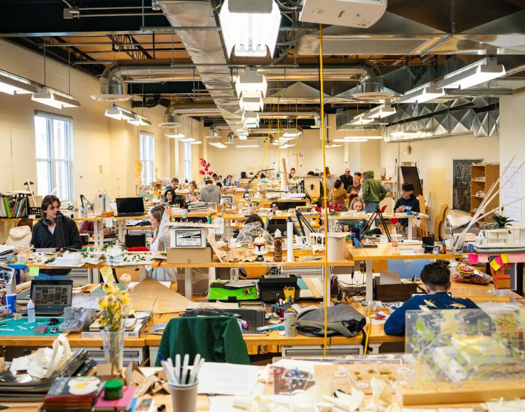 0f50e6313741a202f73c1e92c5b82534 Busy design studio with people working on architectural projects, surrounded by desks, computers, and creative materials. | Sky Rye Design Busy design studio with people working on architectural projects, surrounded by desks, computers, and creative materials.