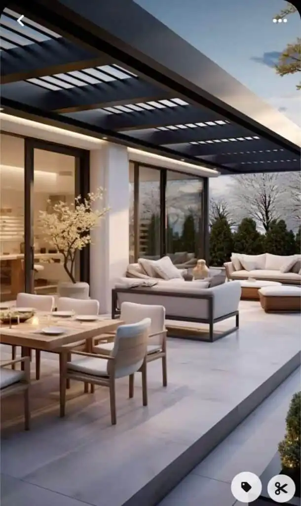 Modern terrace with stylish outdoor seating and dining area under a sleek pergola, surrounded by lush greenery at sunset.