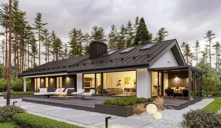 Modern, stylish house with large windows and a sleek design, set amid a lush forested backdrop, perfect for contemporary