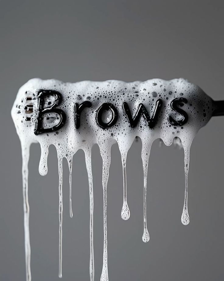 _ 2 The word Brows in black letters covered with sudsy white foam on a dark gray background. | Sky Rye Design The word Brows in black letters covered with sudsy white foam on a dark gray background.