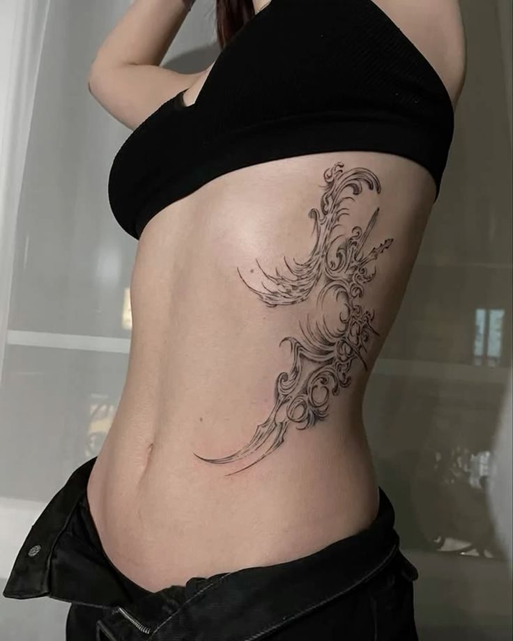 _ - 2026-01-04T191630995 Intricate phoenix tattoo design on the side of a woman's torso, wearing a black crop top and jeans, showcasing body art creativity. | Sky Rye Design Intricate phoenix tattoo design on the side of a woman's torso, wearing a black crop top and jeans, showcasing body art creativity.