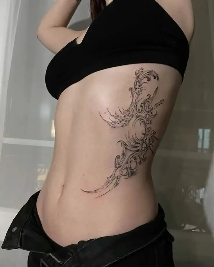 _ - 2026-01-04T191630995 Intricate phoenix tattoo design on the side of a woman's torso, wearing a black crop top and jeans, showcasing body art creativity. | Sky Rye Design Intricate phoenix tattoo design on the side of a woman's torso, wearing a black crop top and jeans, showcasing body art creativity.