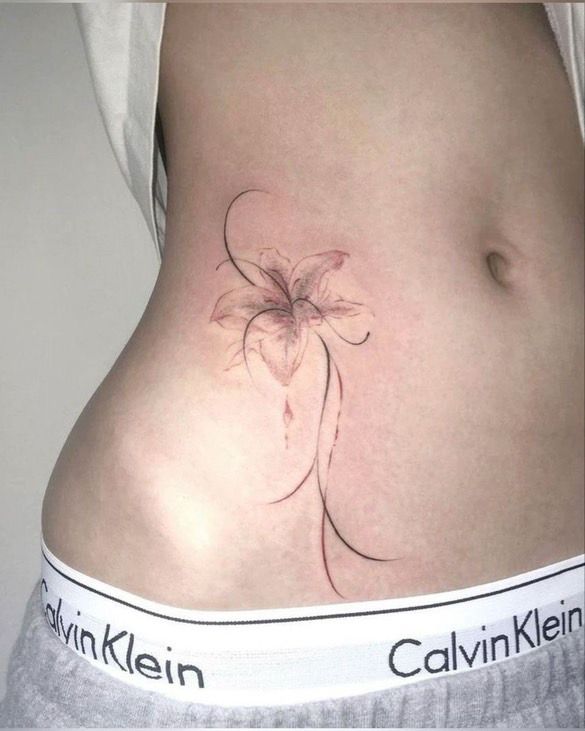 _ - 2026-01-04T192250309 Delicate lily flower tattoo on side of abdomen, showcasing elegant floral design on skin above Calvin Klein waistband. | Sky Rye Design Delicate lily flower tattoo on side of abdomen, showcasing elegant floral design on skin above Calvin Klein waistband.