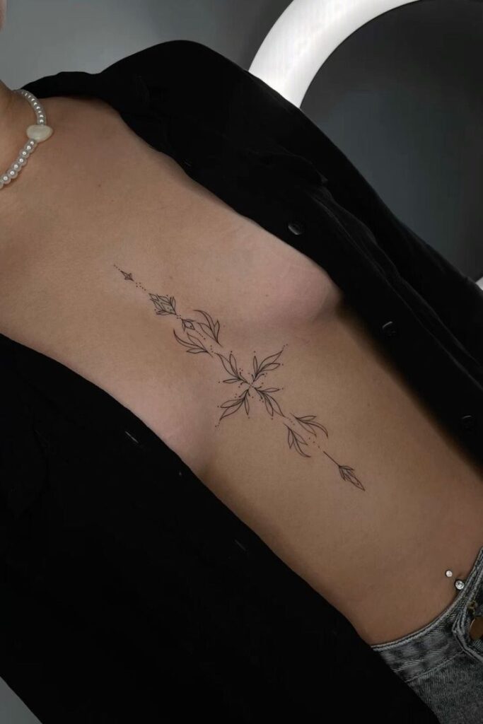 _ - 2026-01-04T193049867 Elegant floral tattoo on lower torso with black ink linework, paired with casual jeans and an open black shirt. | Sky Rye Design Elegant floral tattoo on lower torso with black ink linework, paired with casual jeans and an open black shirt.