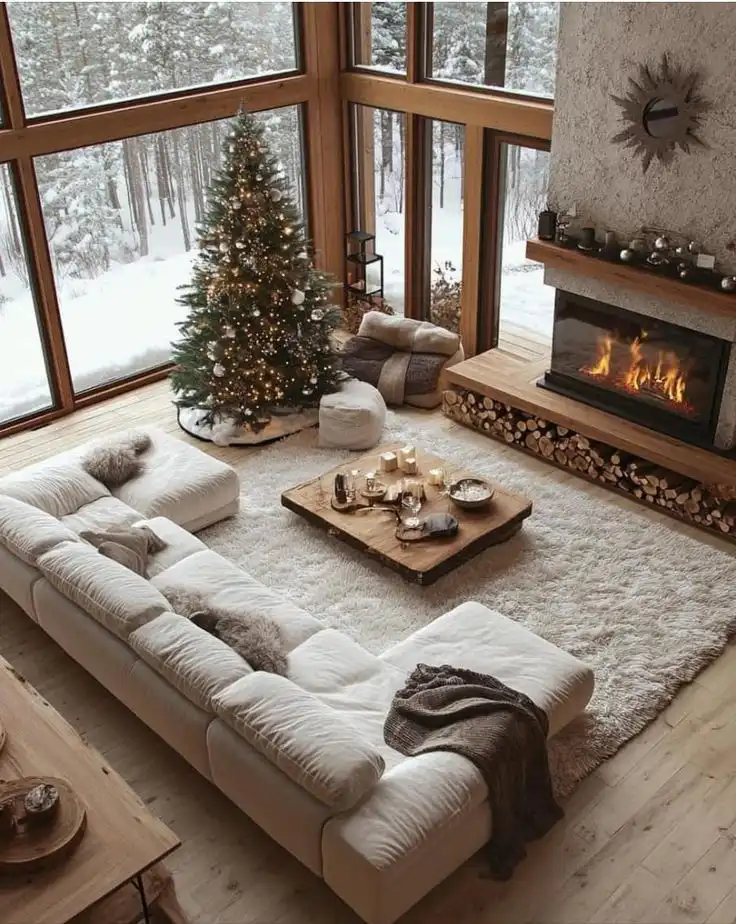 _ 29 Cozy winter living room with Christmas tree, large windows, white sofa, and fireplace, creating a warm and inviting atmosphere. | Sky Rye Design Cozy winter living room with Christmas tree, large windows, white sofa, and fireplace, creating a warm and inviting atmosphere.