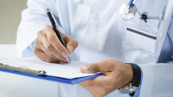 3 Truly Terrible and Common Ways to Diagnose ADHD Doctor writing on a clipboard, wearing a white coat with a stethoscope, symbolizing healthcare and medical documentation. | Sky Rye Design Doctor writing on a clipboard, wearing a white coat with a stethoscope, symbolizing healthcare and medical documentation.