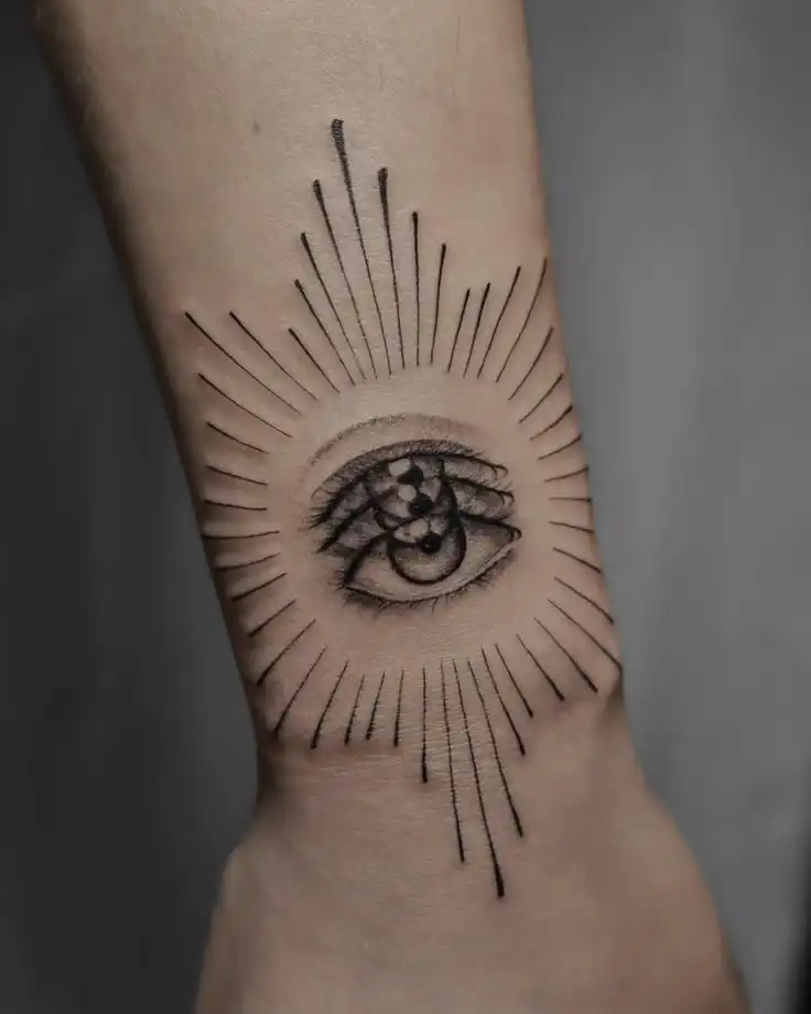 30 Best Eye Tattoo Ideas You Should Check Tattoo of an eye with geometric designs and radiating lines on a forearm, combining mystic and modern artistic elements. | Sky Rye Design Tattoo of an eye with geometric designs and radiating lines on a forearm, combining mystic and modern artistic elements.