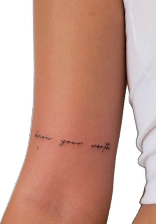 43 Beautiful empowering self love tattoo ideas - Grace Mastered Minimalist know your worth tattoo on person's arm, featuring delicate black script on light skin. | Sky Rye Design Minimalist know your worth tattoo on person's arm, featuring delicate black script on light skin.