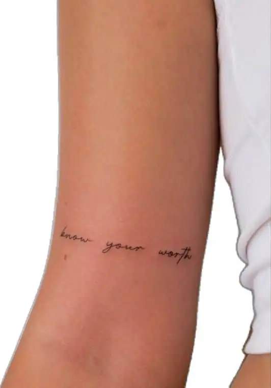 Minimalist know your worth tattoo on person's arm, featuring delicate black script on light skin.