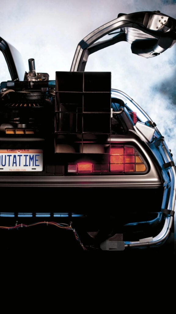 Rear view of a futuristic car with open doors and OUTATIME license plate, conveying a sense of adventure and time travel.