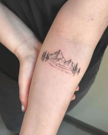 50 Beautiful Mountain Tattoo Ideas For Every Aesthetic In 2025 Minimalist mountain and forest tattoo on forearm, showcasing nature-inspired art in black ink. | Sky Rye Design Minimalist mountain and forest tattoo on forearm, showcasing nature-inspired art in black ink.