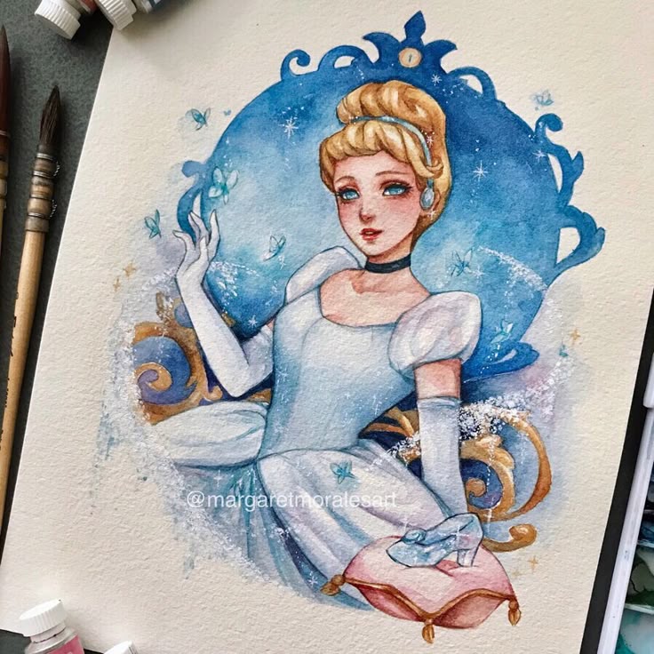 _ 59 Illustrated princess in a blue dress, surrounded by butterflies, painted with watercolor, brushes and paints nearby. | Sky Rye Design Illustrated princess in a blue dress, surrounded by butterflies, painted with watercolor, brushes and paints nearby.