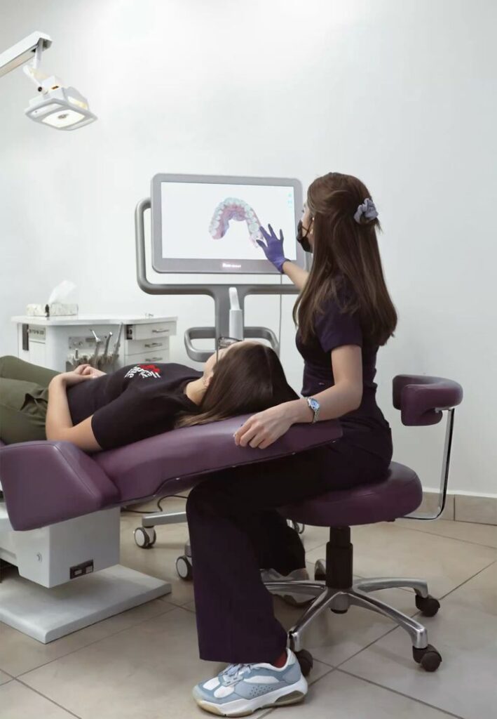 7422931d279160b4ad31bc25fcfb7d18 Dentist demonstrating a digital dental scan to a patient in a clinic, highlighting modern oral care technology. | Sky Rye Design Dentist demonstrating a digital dental scan to a patient in a clinic, highlighting modern oral care technology.
