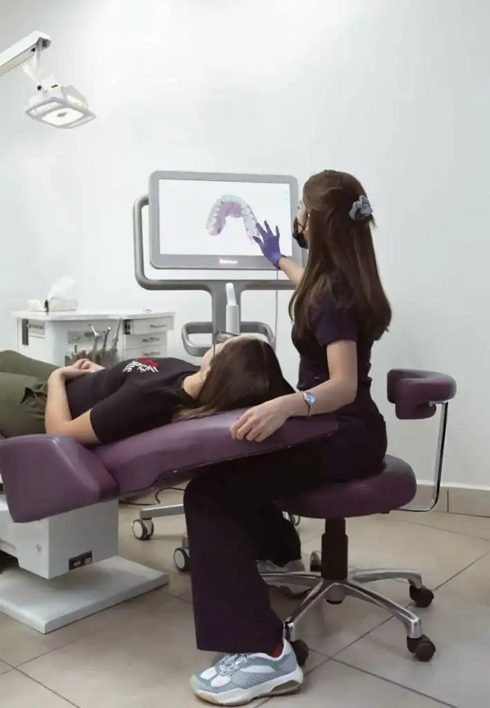 7422931d279160b4ad31bc25fcfb7d18 Dentist demonstrating a digital dental scan to a patient in a clinic, highlighting modern oral care technology. | Sky Rye Design Dentist demonstrating a digital dental scan to a patient in a clinic, highlighting modern oral care technology.