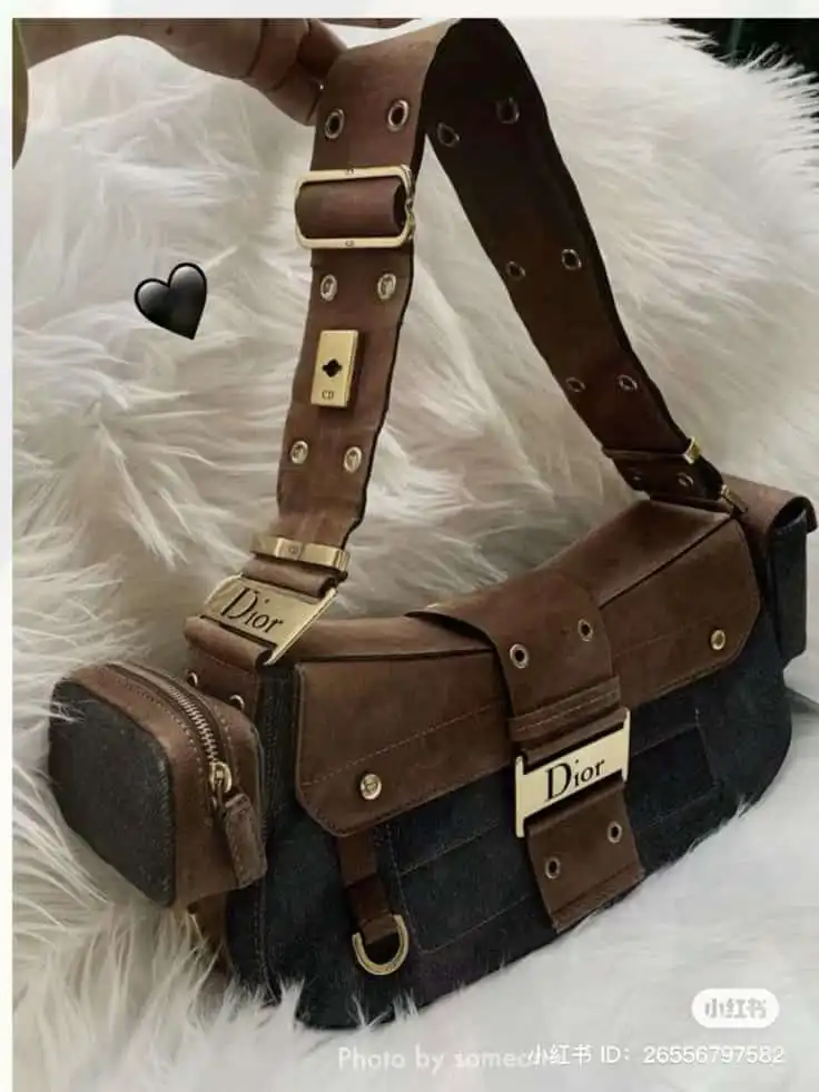 Brown designer handbag with gold accents and denim details on a white faux fur background. 2026 Bag Trends