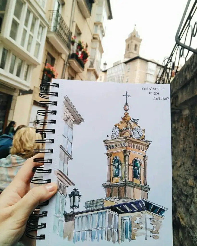 Sketch of a clock tower in a street scene, capturing architectural details and vibrant city life, held with surrounding buildings in view.
