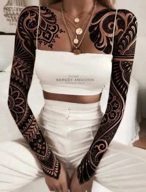 Woman in white outfit with intricate black full sleeve tattoos, wearing layered necklaces. Fashion and tattoo art concept.