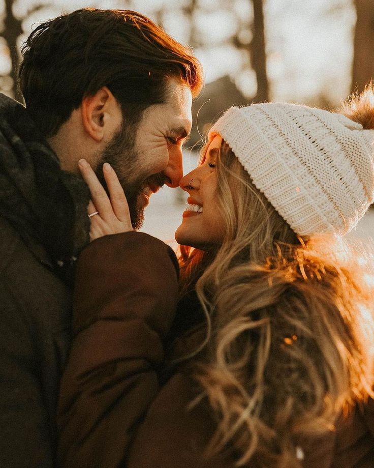 _ 9 A couple enjoying a cozy winter moment, sharing a loving gaze under the warm sunset, wrapped in coats and a knitted beanie. | Sky Rye Design A couple enjoying a cozy winter moment, sharing a loving gaze under the warm sunset, wrapped in coats and a knitted beanie.