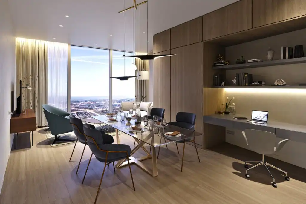 Modern dining room and workspace with city view, featuring a glass table, stylish chairs, and a sleek built-in desk with shelving.