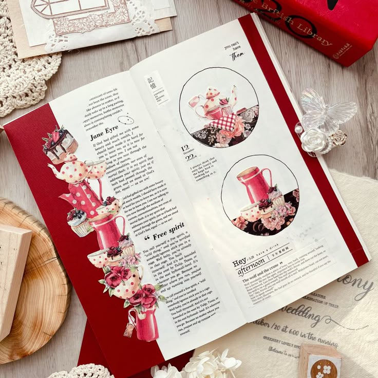 _ 97 Open book with floral teapot illustrations on a wooden table, surrounded by doilies and decorative items, enhancing a vintage aesthetic. | Sky Rye Design Open book with floral teapot illustrations on a wooden table, surrounded by doilies and decorative items, enhancing a vintage aesthetic.