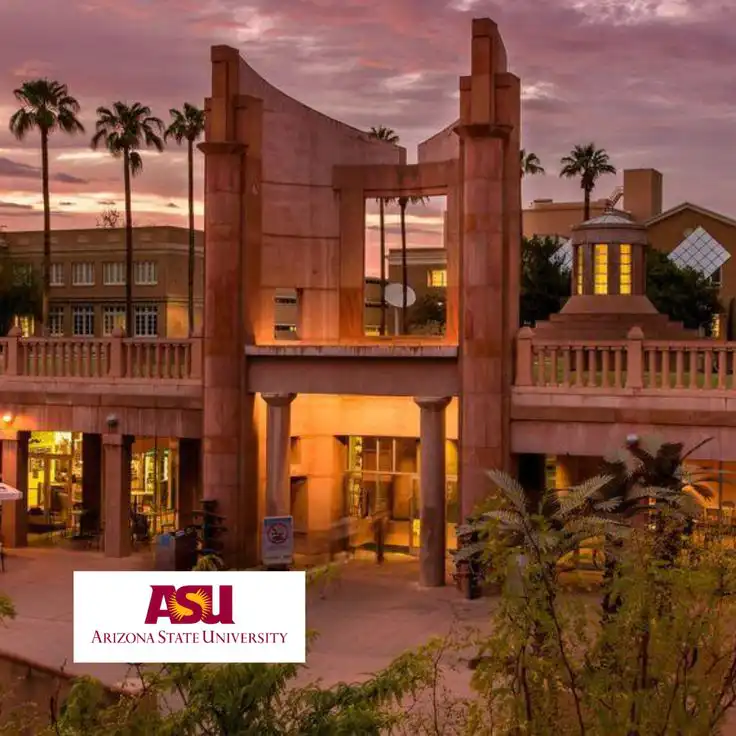 Arizona State University campus entrance at sunset, showcasing iconic architecture and palm trees.