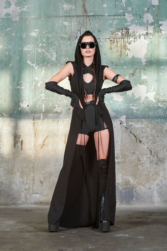 Berlin Pride_ Fashion Beyond Boundaries Fashion model in edgy black outfit with cutouts, standing confidently against a textured urban wall. Trendy, bold, and | Sky Rye Design Fashion model in edgy black outfit with cutouts, standing confidently against a textured urban wall. Trendy, bold, and