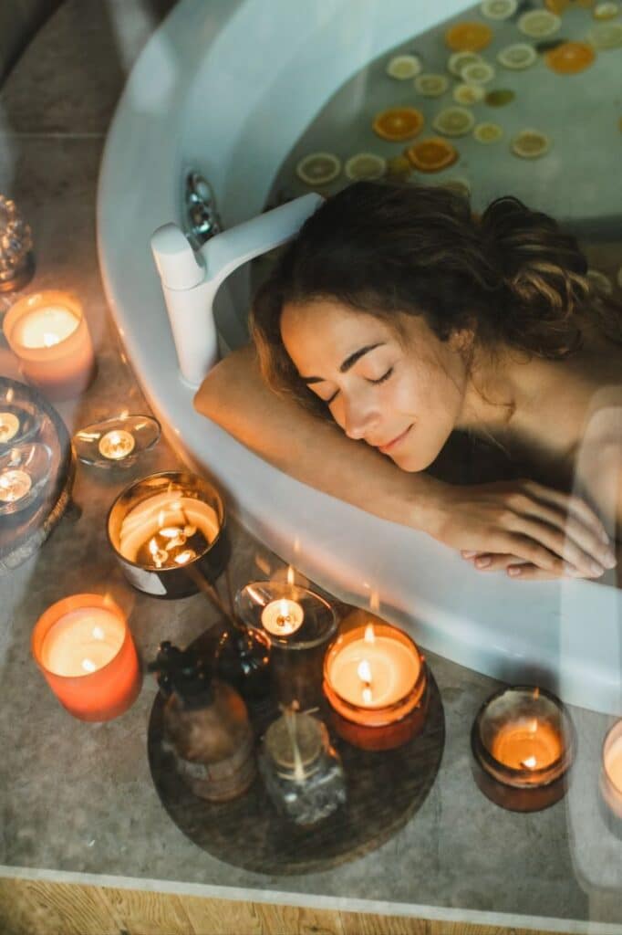 Best spa deals 2023 Woman relaxing in a bathtub with candlelight and citrus slices, creating a serene spa atmosphere for relaxation and rejuvenation. | Sky Rye Design Woman relaxing in a bathtub with candlelight and citrus slices, creating a serene spa atmosphere for relaxation and rejuvenation. Spa Massages