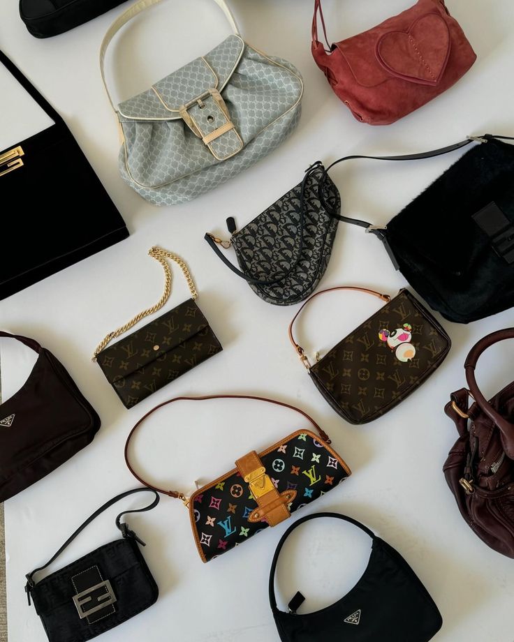 Bts of prepping for our biggest drop yet 📸 A A stylish assortment of luxury handbags displayed on a white surface, including various colors and designs for fashion enthusiasts. | Sky Rye Design A stylish assortment of luxury handbags displayed on a white surface, including various colors and designs for fashion enthusiasts.