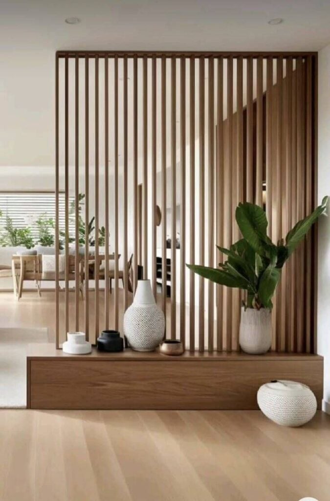 Financing Tips for Big Home Improvement Projects 1 Modern living room with wooden slat divider, decorative vases, and lush plant, creating a stylish and natural ambiance. | Sky Rye Design Modern living room with wooden slat divider, decorative vases, and lush plant, creating a stylish and natural ambiance.