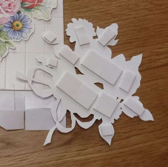 How to Use 3D Scrapbook Adhesive Squares for Crafting Layered floral die-cut pieces with adhesive foam squares on a wooden surface for crafting or scrapbooking projects. | Sky Rye Design Layered floral die-cut pieces with adhesive foam squares on a wooden surface for crafting or scrapbooking projects.