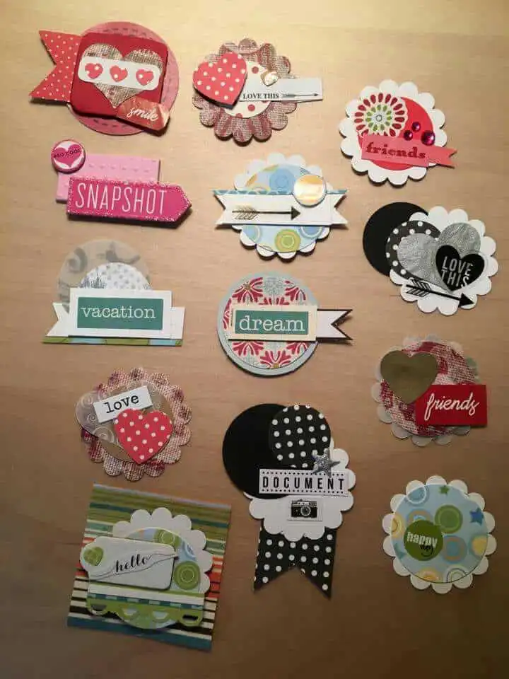 Colorful scrapbook embellishments with words like friends, dream, and love on various patterned papers and shapes.