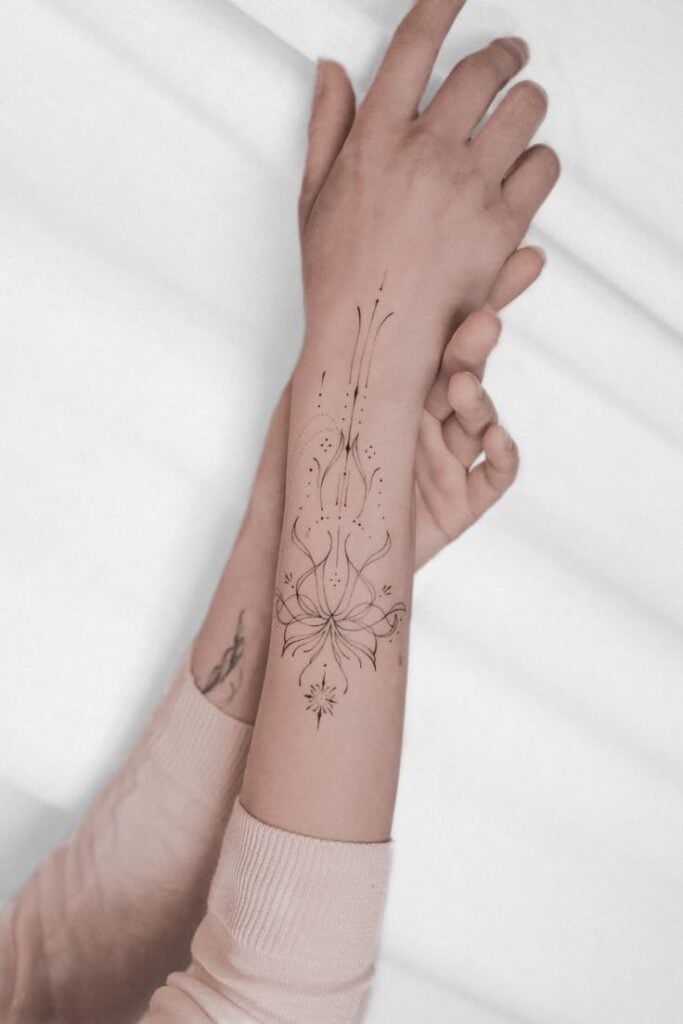 Elegant floral tattoo design on forearm, with intricate lines and symbols, showcased on a neutral background for aesthetic appeal.