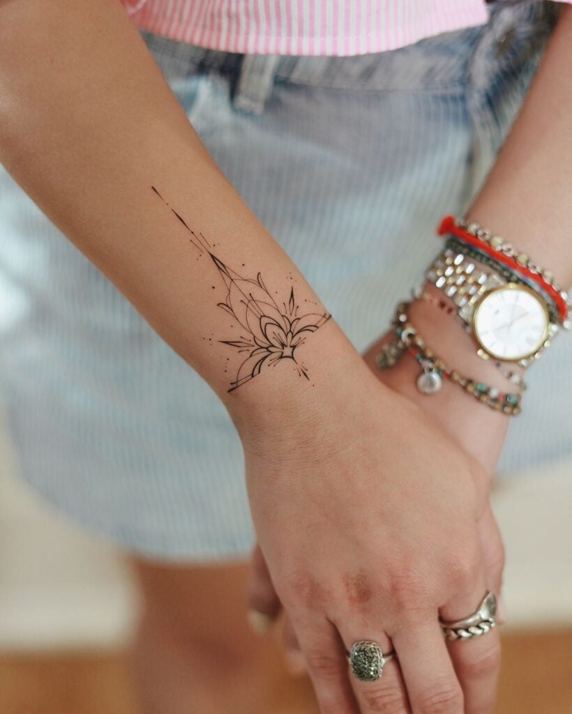 Stylish floral wrist tattoo design with bracelets and a watch, expressing personal style and elegance in summer attire.